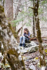 A student from Whitesburg Christian Academy in Huntsville, Alabama, enjoys a quiet moment with her journal on Tremont’s campus. Photo by Rich Bryant, courtesy of Great Smoky Mountains Institute at Tremont. 