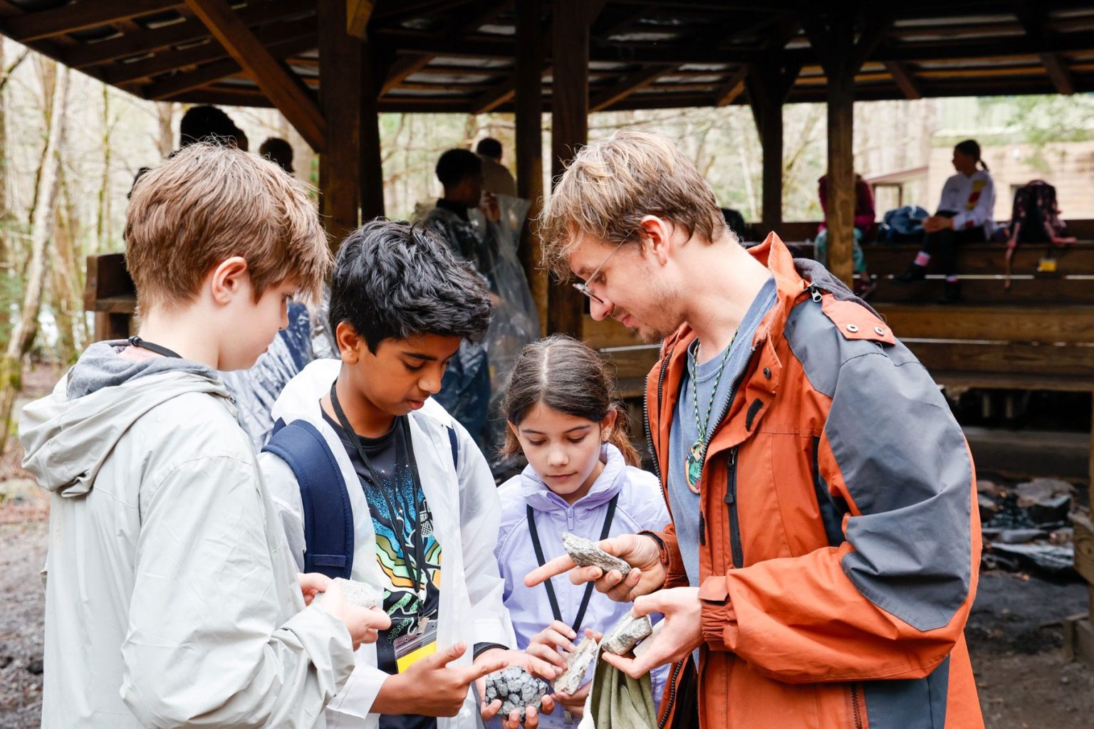 Tremont Teacher-Naturalist Jeremy Johnson talks rocks with a group of students from Rockwood School District in Missouri. Photo by Rich Bryant, courtesy of Great Smoky Mountains Institute at Tremont.