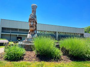 The exterior of the Museum of the Cherokee Indian is distinguished by a prominent statue of Sequoyah (c. 1770–1843), the brilliant creator of the Cherokee syllabary. Formally adopted by the Cherokee Nation in 1825, Sequoyah’s syllabary established a vital system of reading and writing in the Cherokee language. Image courtesy of the Museum of the Cherokee Indian.