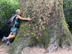 Nancy East hugging a tree