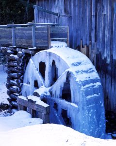 Snow and ice cover the Cable Mill at Cades Cove Visitor Center toward the far end of Cades Cove Loop Road. Photographs taken on a cloudy, dreary day may take on a blue cast. Setting your camera to automatic white balance will mitigate this. If you are taking images in RAW format for later processing, then you can adjust to taste. The blue imparts a feeling of coldness to the image, consistent with the snow and ice, so it is not necessarily a fault. Photo by Nye Simmons.