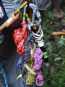 Technical rescue skills are regarded as “perishable,” meaning that they must be practiced regularly to keep the SAR crew’s capabilities honed and ready for rapid deployment. Team members wear climbing harnesses bearing brightly colored bundles of rope slings and clusters of metal climbing devices — tools of the tech-rescuer’s trade — on the side loops of their harnesses. Photo by David Brill.