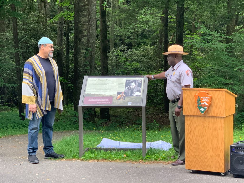 Eric Mingus and GSMNP Superintendent Cassius Cash unveil a new sign outside Mingus Mill in Great Smoky Mountains National Park at a ceremony held Tuesday, May 23, 2023. The new sign describes how the Mingus family experience in America touches on “some of the country’s sharpest historical notes.” Provided by Great Smoky Mountains Association.
