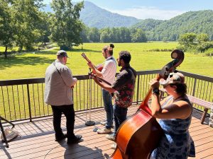 The Tray Wellington Band soundchecks ahead of their performance at Oconaluftee Visitor Center in Great Smoky Mountains National Park on Saturday, July 29, 2023. Accompanying Tray Wellington in the Tray Wellington Band are Josiah Nelson, Nick Weitzenfeld, and Katelynn Lowe (from left to right). Photo provided by NPS.