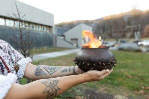 A traditional Cherokee firepot holds a flame in front of what is now the newly rebranded Museum of the Cherokee People in Cherokee, North Carolina. Museum exhibitions present both new works by contemporary artists and cultural objects that date back thousands of years. Image courtesy Museum of the Cherokee People.