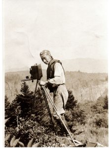 George Masa posing in field with three view cameras on tripods circa 1920-30. Courtesy of Horace Kephart Family Collection, GSMA.