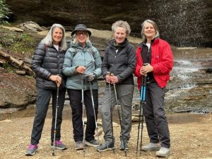The “Sisters of the Woods”— (from left) Phyllis Woollen , Jana Plemmons, Katie Ray and Judy Dykes—celebrate completing the 100 Favorite Trails of the Smokies and Carolina Blue Ridge map at Moore Cove Falls near Brevard, North Carolina. Photo provided by Anne Glover.