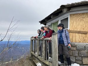 After an arduous hike along a snowy January trail, the group takes in the view from the Mount Cammerer Lookout Tower in Great Smoky Mountains National Park. Photo provided by Phyllis Woollen. 