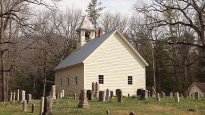 After his exoneration for the murder of George Powell Jr., “Uncle Sam” Burchfield went on to enjoy a certain amount of regional celebrity. He is buried in the Cades Cove Primitive Baptist Church Cemetery under a memorial that reads “Sam Burchfield ‘Long Hair’ of Chestnut Flats 1840–1917.” Provided by NPS.