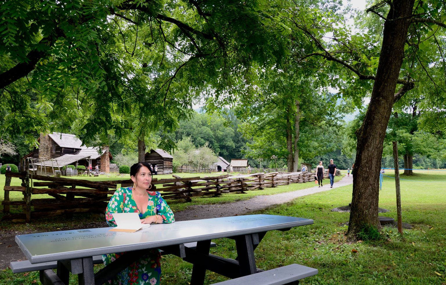 Ada Limón, the 24th poet laureate of the United States, sits at the newly unveiled picnic table in Great Smoky Mountains National Park, which features the poem “the earth is a living thing” by Lucille Clifton. Photo provided by Holly Kays, Smokies Life.