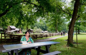 Ada Limón, the 24th poet laureate of the United States, sits at the newly unveiled picnic table in Great Smoky Mountains National Park, which features the poem “the earth is a living thing” by Lucille Clifton. Photo provided by Holly Kays, Smokies Life. 