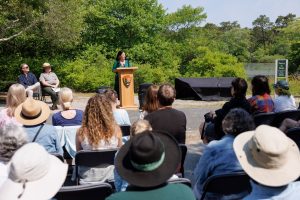 US Poet Laureate Ada Limón speaks to a crowd at the unveiling of a poetry installation on a picnic table at Cape Cod National Seashore on June 14. Photo provided by Shawn Miller, Library of Congress.