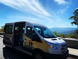 A hiker shuttle operated by Gatlinburg-based A Walk in the Woods stops at a pullout in Great Smoky Mountains National Park. A Walk in the Woods is one of seven companies partnering with the park to provide shuttle services to its trailheads and one of five such companies in Tennessee. Photo provided by A Walk in the Woods Guide Service. 