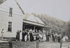 In a 1936 photo, Cataloochee community members gather on the porch of the Woody house. It was at the picnic where this photo was taken that the idea for an annual reunion was conceived. Photo provided by Steve Woody.