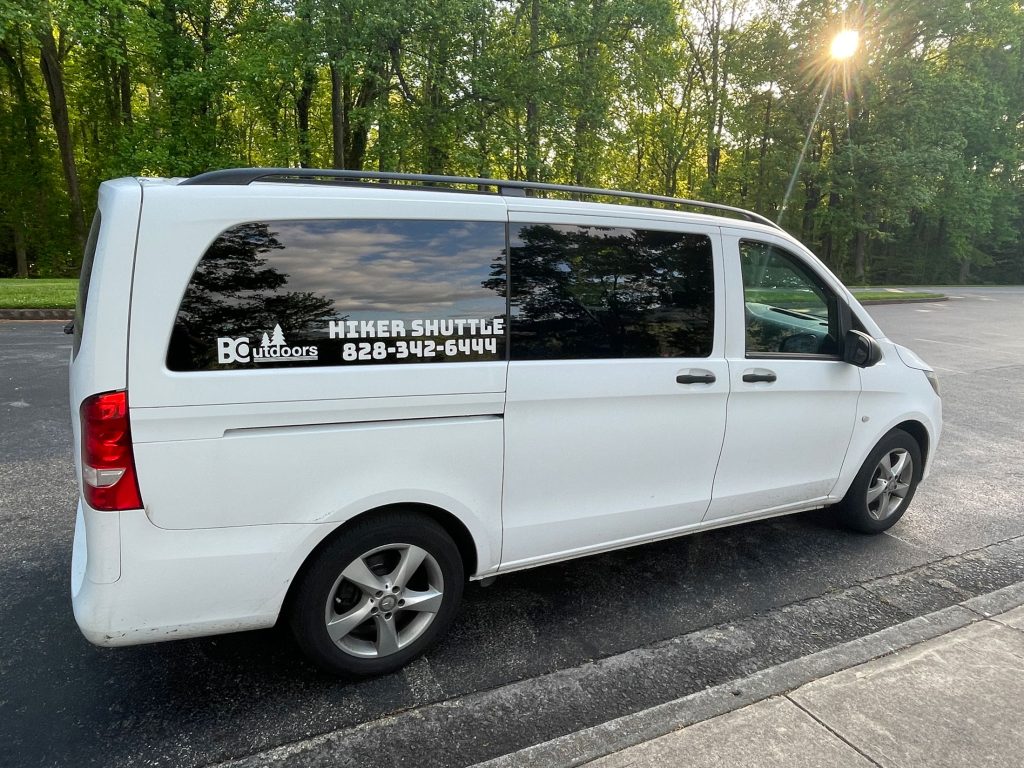 A hiker shuttle operated by Bryson City Outdoors, which has locations in Cherokee and Bryson City, stops at a pullout in Great Smoky Mountains National Park. Bryson City Outdoors is one of seven companies partnering with the park to provide shuttle services to its trailheads and one of two such companies in North Carolina. Photo provided by Bryson City Outdoors.