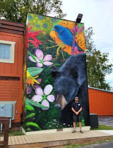 The finished mural, created by Curtis Glover of Curtis Glover Creative, is bursting with life and color that mirrors the diversity found within the park itself. It is painted on the walls of the Great Smokies Welcome Center, which opened this year in Townsend. Photo provided by Curtis Glover Creative. 