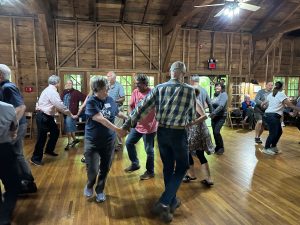 Smoky Mountains Hiking Club members light up the dance floor during a square dance held in conjunction with the club’s centennial year celebration on May 11 at the Appalachian Clubhouse in Elkmont. Photo provided by Smoky Mountains Hiking Club.