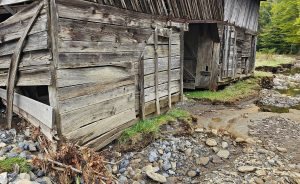 Crews are working to stabilize Caldwell Barn in Cataloochee Valley after it sustained significant damage from flooding on Rough Fork Creek. Photo provided by National Park Service. 