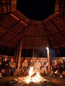 Conference attendees gather around a fire on Tremont’s campus during the conference’s opening night. Photo provided by Valerie Polk. 