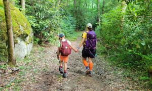 Landon Stewart holds his mom's hand toward the end of a long day on Wolf Ridge Trail. Photo by Korrin Bishop.