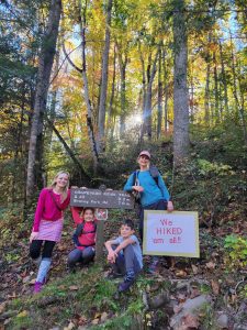 From left, Korrin Bishop (author), E. C. Stewart, Landon Stewart, and Jennifer Stoneking-Stewart take a celebratory photo at the end of their Smokies 900 Miler hike. Courtesy of Korrin Bishop.