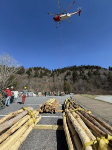 The locust logs await an airlift from the staging area at Oconaluftee Overlook, less than a mile south of Newfound Gap, as the helicopter picks up a bundle of supplies destined for LeConte Lodge. Photo by Anne Sentz, courtesy of Appalachian Trail Conservancy.