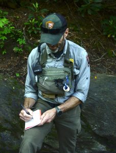 Supervisory PSAR Ranger Joshua Albritton takes notes after assisting a hiker at Arch Rock. These notes are used to create statistics to help make the PSAR team even more effective in the years to come. Photo by Holly Kays, courtesy of Smokies Life.