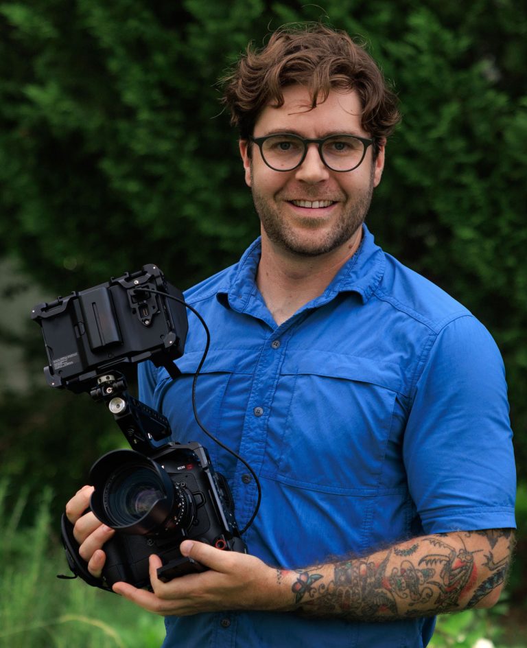 Photo pf Robin Pyle holding a video camera
