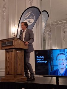 Tim Kelly, the mayor of Chattanooga, Tennessee speaks to a crowd at a lecture stand