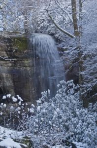 A frozen waterfall in the middle of a winter scene