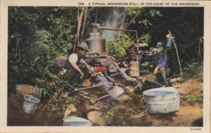 A postcard from the 1930s featuring a photo of moonshiners around a still