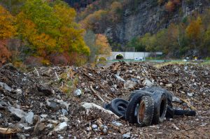 Debris including vehicle tires with a double tunnel in the background