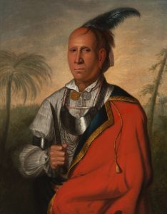 Painting of a cherokee man wearing half a red coat