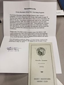 A typed piece of paper beside a Carolina Mountain Club pamphlet